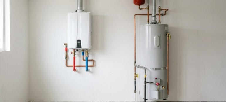 Modern wall-mounted tankless water heater next to a traditional cylindrical tank-style water heater, a side-by-side comparison for Utah homeowners.